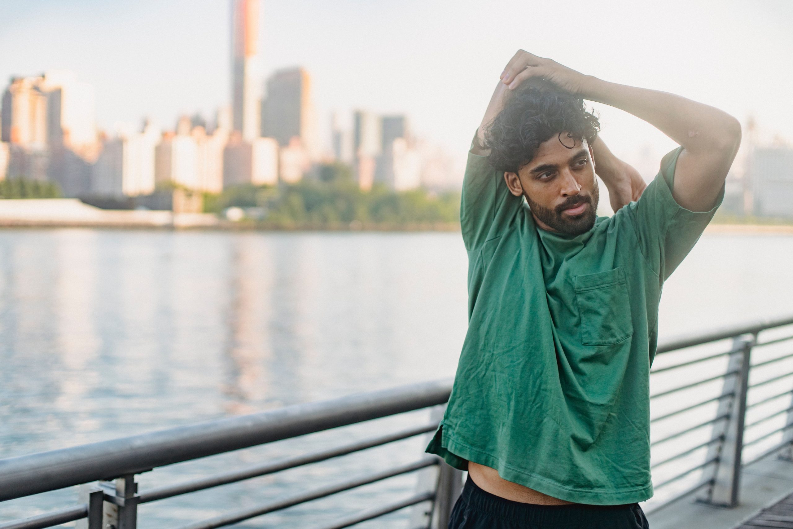 Person stretching outdoors during recovery, staying active in Canada